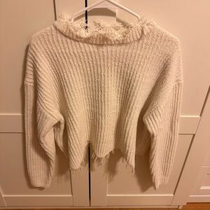 Distressed cream sweater